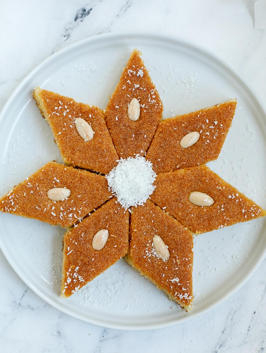 Seven pieces of Coconut Basbousa placed in a star shape.