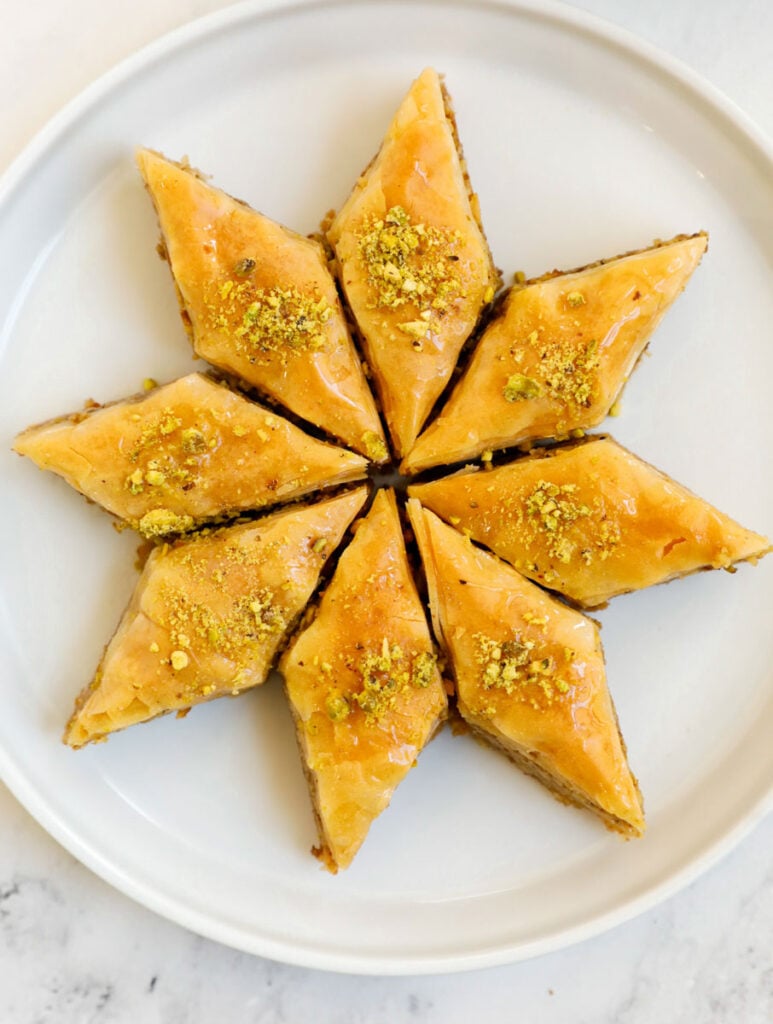 A plate with eight portions of walnut baklava.