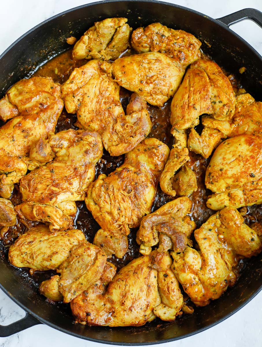 Chicken shawarma being seared in a cast iron after cooking