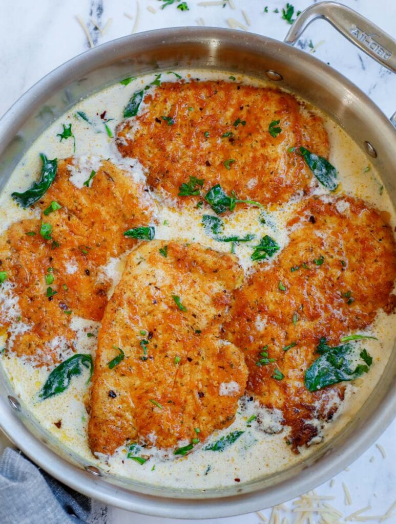 Seared chicken breasts in a parmesan cream sauce.