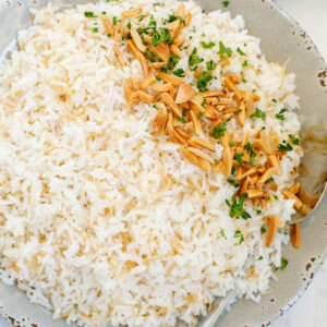 Top down view of of cooked vermicelli rice on a plate, garnished with toasted almonds and parsly
