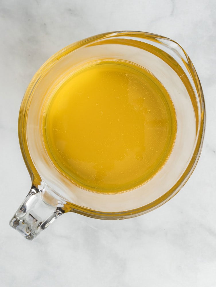 Overhead view of ghee in a measuring cup.