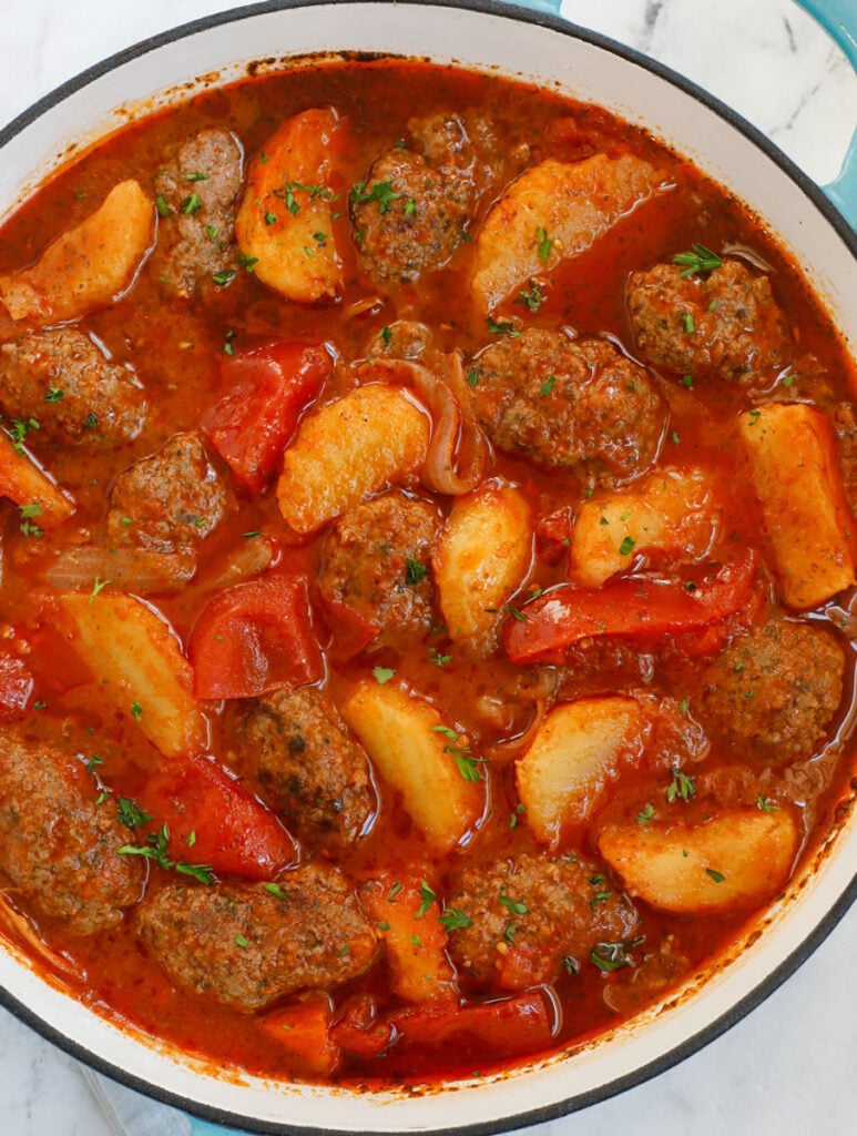 Kafta and potato stew in a dutch oven.