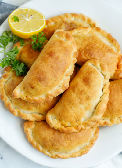 A platter of freshly baked individual meat pies.