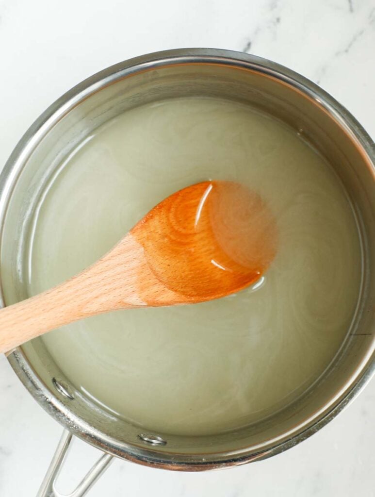 Stirring ingredients for syrup in a sauce pan.