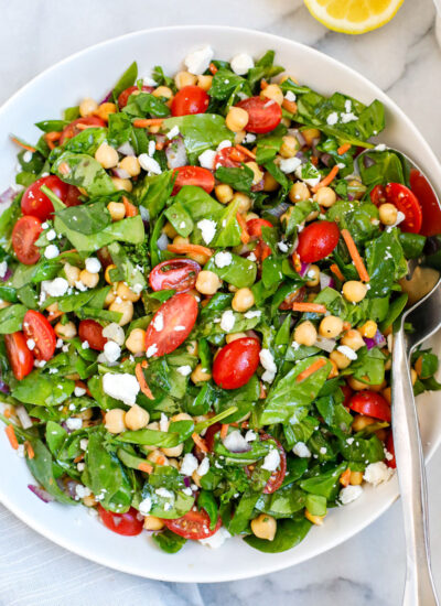 A plate of chickpea and spinach salad.