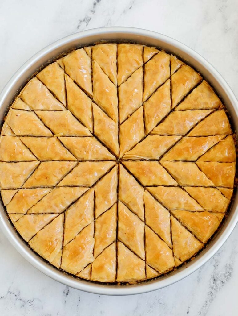 Baked walnut baklava cut into diamond shapes.