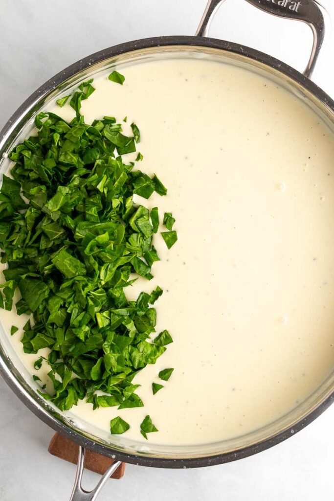 spinach added to the creamy sauce