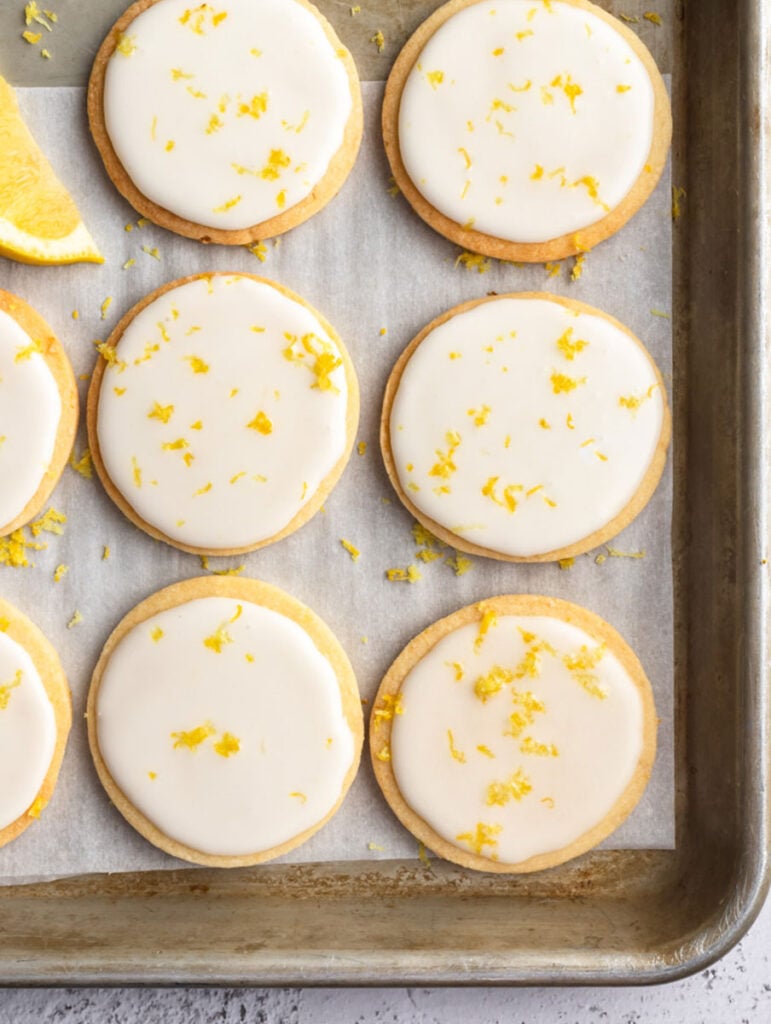 top down shot showing the lemon cookies with icing on a sheet pan