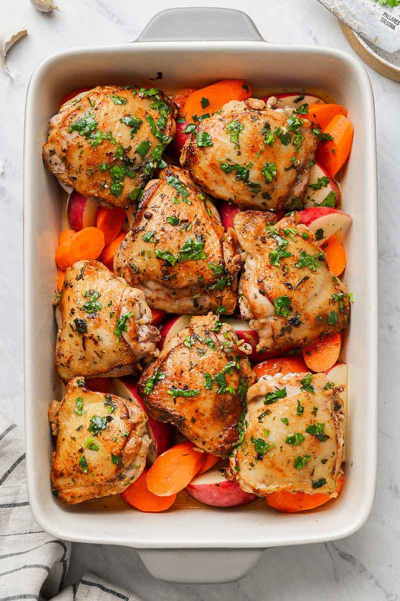 Chicken thighs in a baking dish with veggies