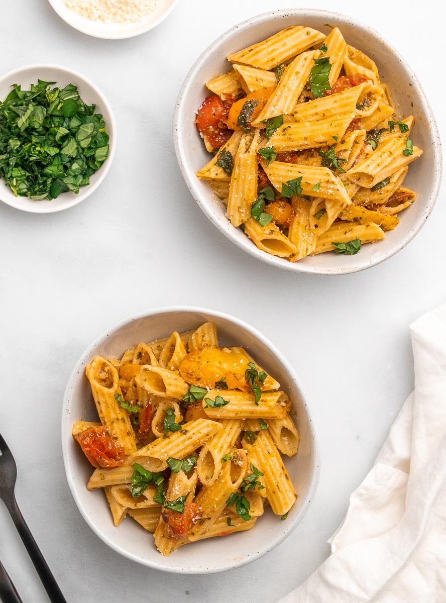 top down view of two bowls of cherry tomato pesto pasta