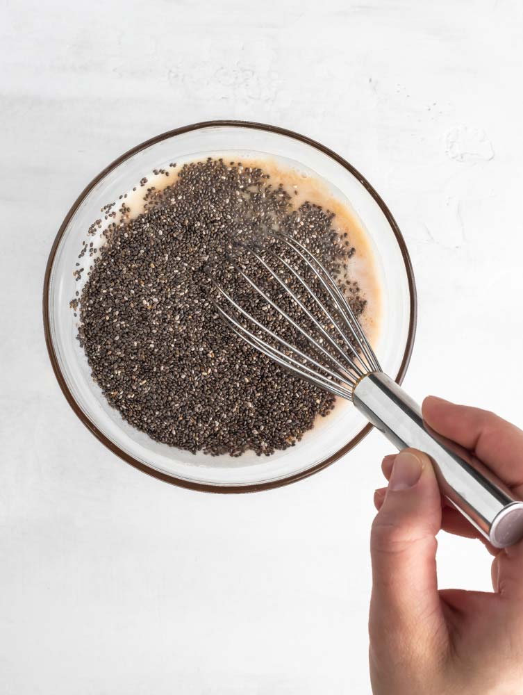 chia and milk being mixed in a bowl