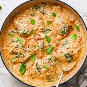 top down view of the creamy chicken thighs dish, garnished with basil leaves