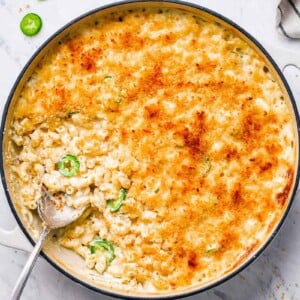 top down shot of mac in a skillet with a spoon in the skillet