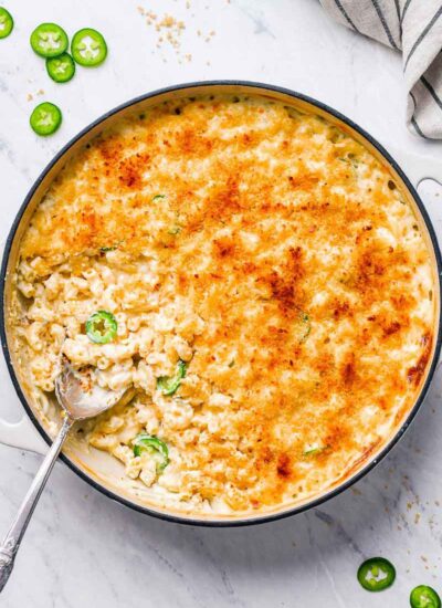 top down shot of mac in a skillet with a spoon in the skillet