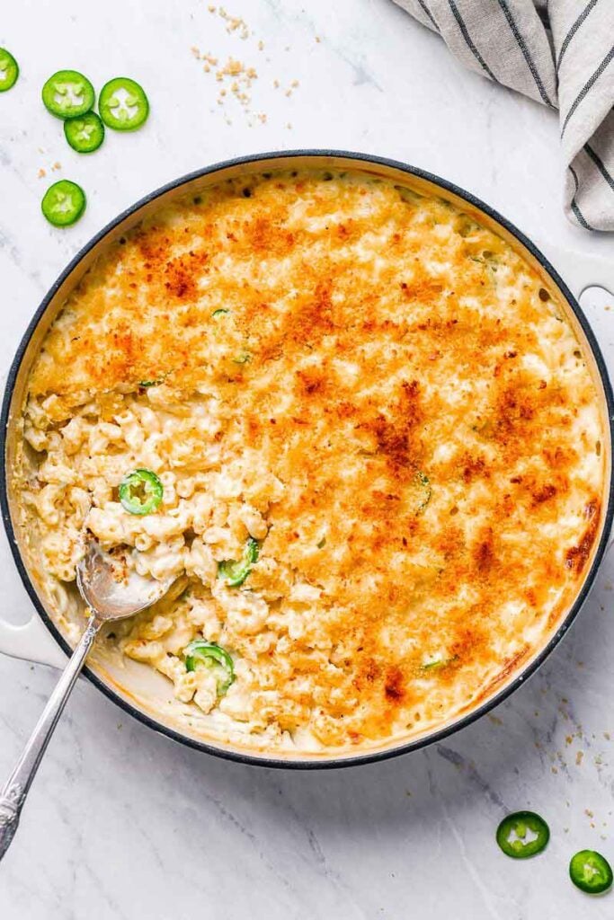 top down shot of mac in a skillet with a spoon in the skillet