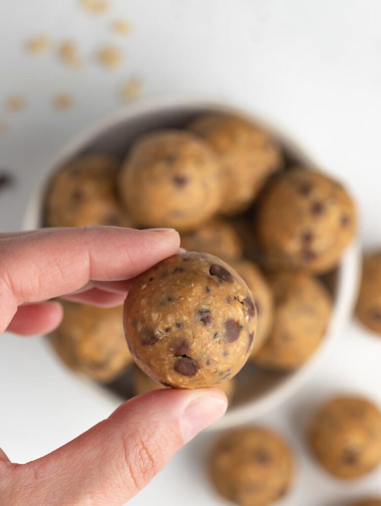 female hand holding one energy ball with two finger