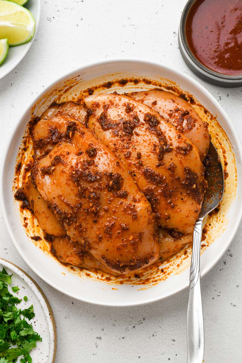 top down shot of marinated bbq chicken breast before cooking