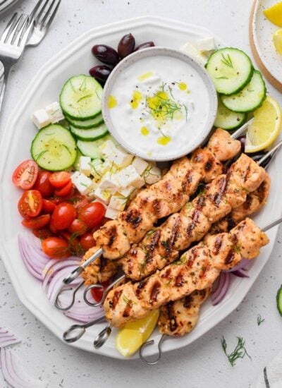 top down shot of the greek chicken skewer dish served with sides