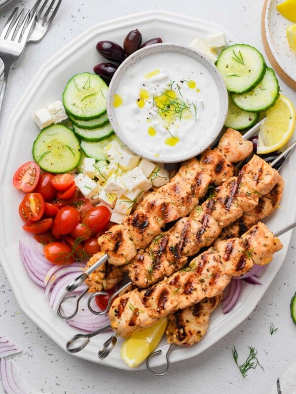 top down shot of the greek chicken skewer dish served with sides