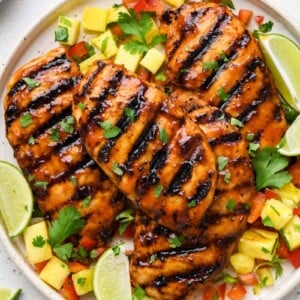 top down shot of the bbq chicken breast on a plate with garnishes