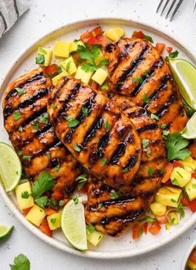 top down shot of the bbq chicken breast on a plate with garnishes