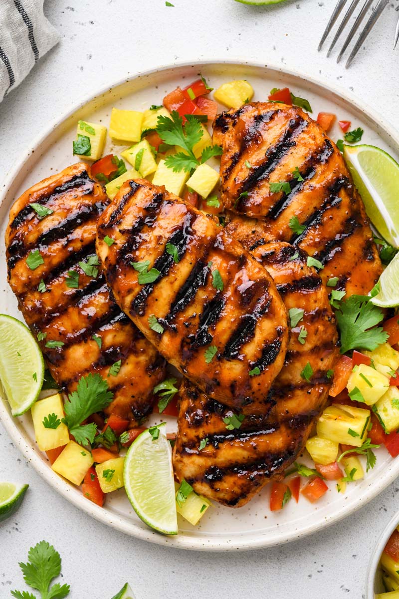 top down shot of the bbq chicken breast on a plate with garnishes