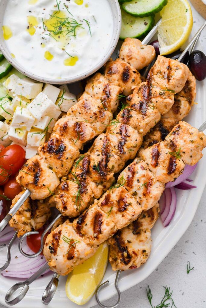 Close up shot of the Greek chicken skewers on a plate