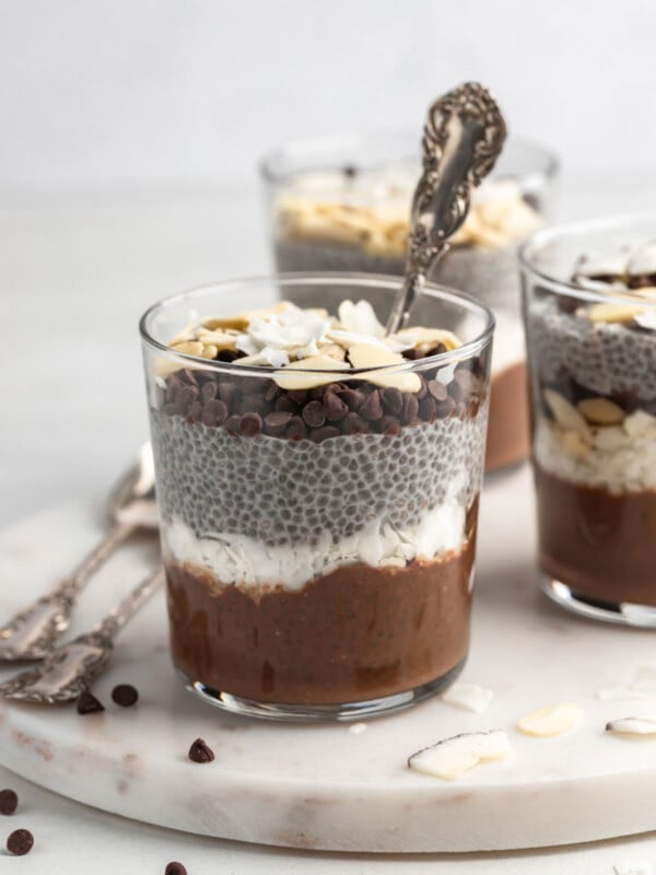 front view shot of almond joy chia pudding with a spoon in the cup