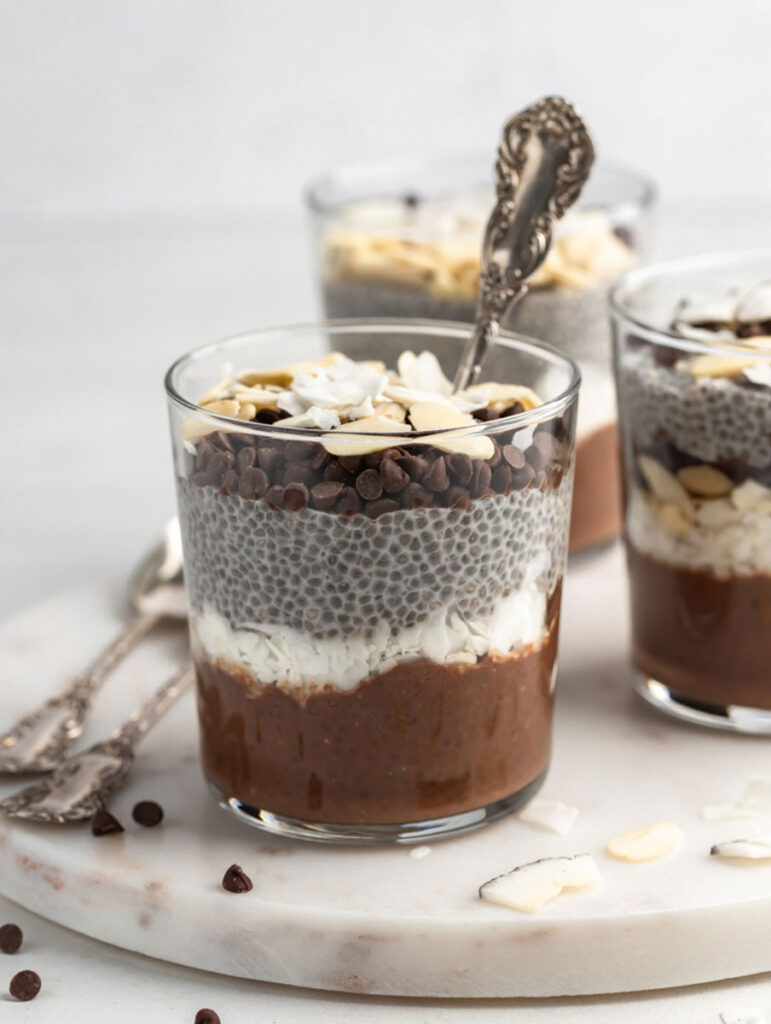 front view shot of almond joy chia pudding with a spoon in the cup