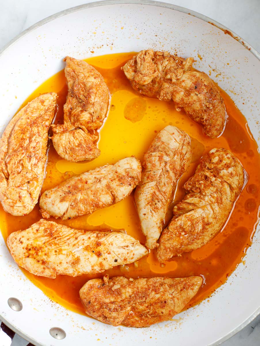 Chicken cooked in a pan.