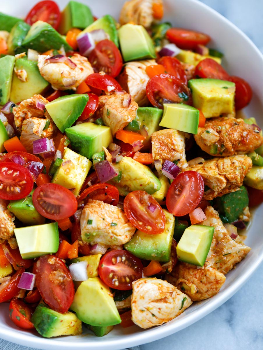 Close up view of a bowl of avocado chicken salad.