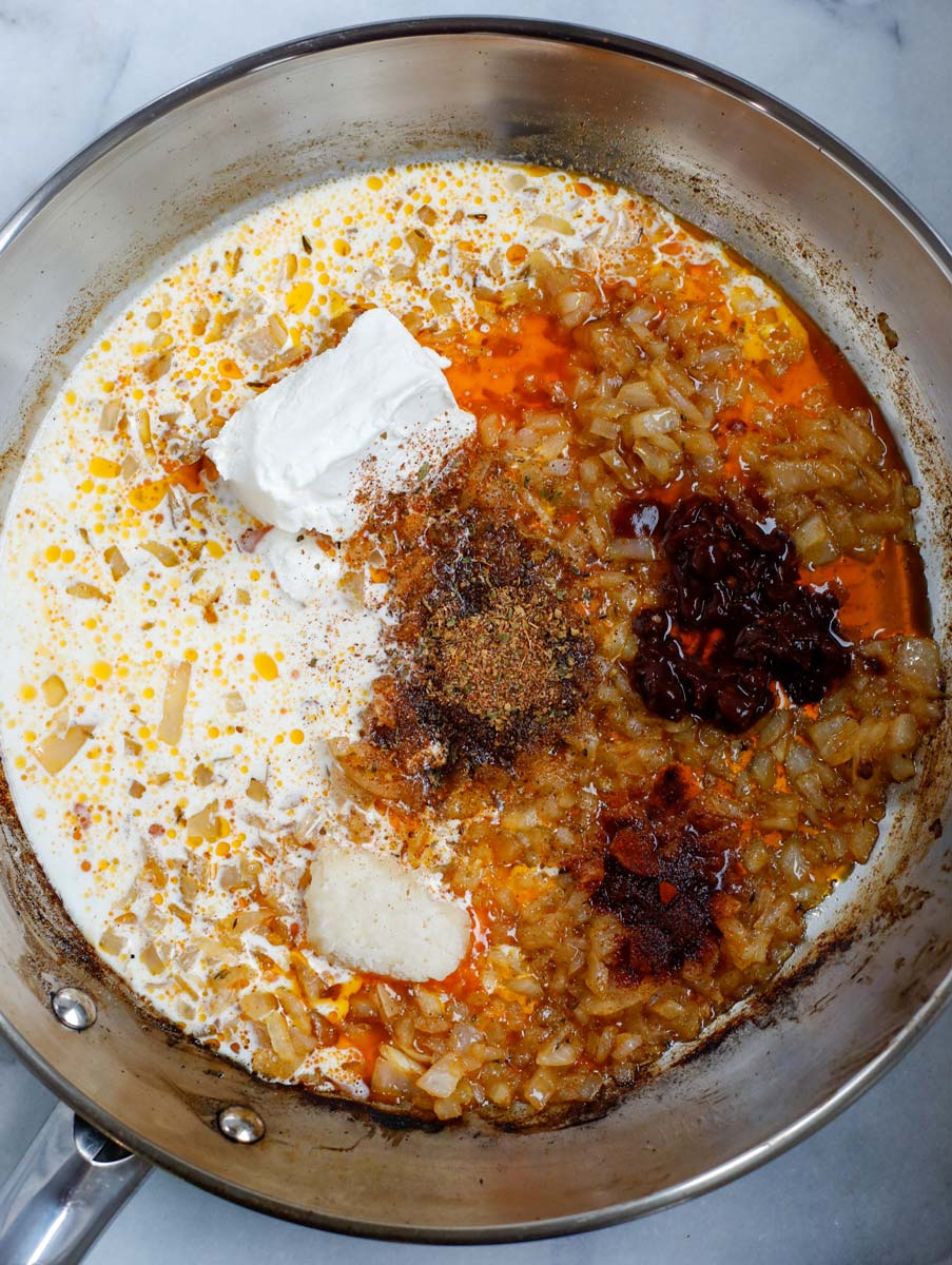 Ingredients for the cajun sauce inside of a pan.