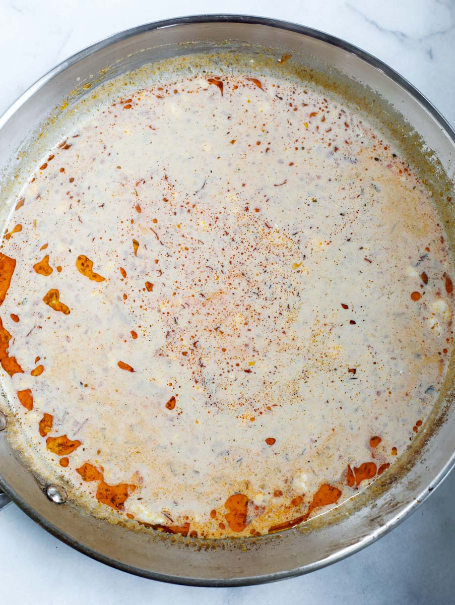 Creamy cajun sauce being made in a pan.