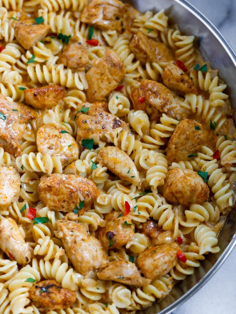 Close up of a pan of creamy chicken cajun pasta.