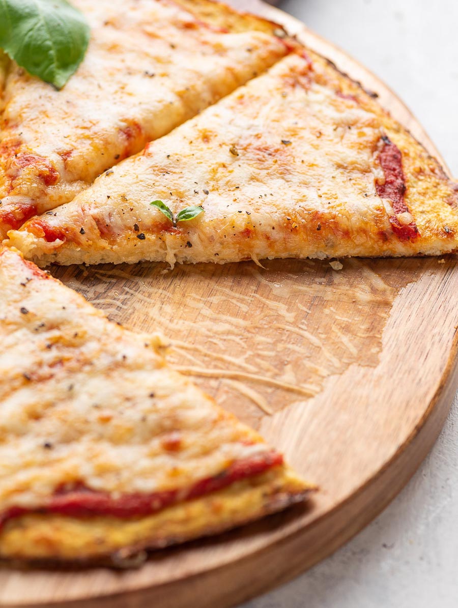 close up shot showing a slice of cauliflower pizza