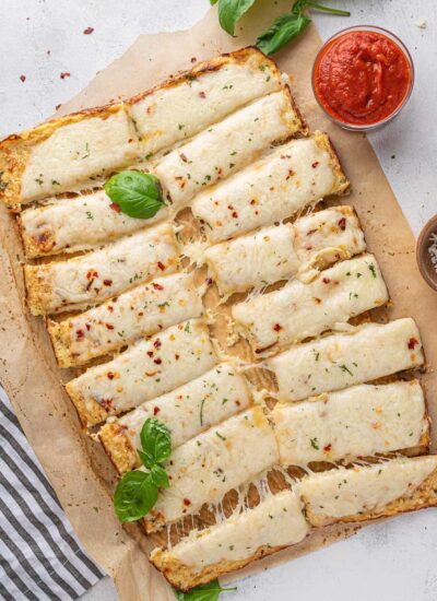 top down shot of cauliflower sticks with basil leaves on top