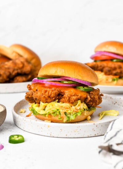 A plate with a fried chicken sandwich.