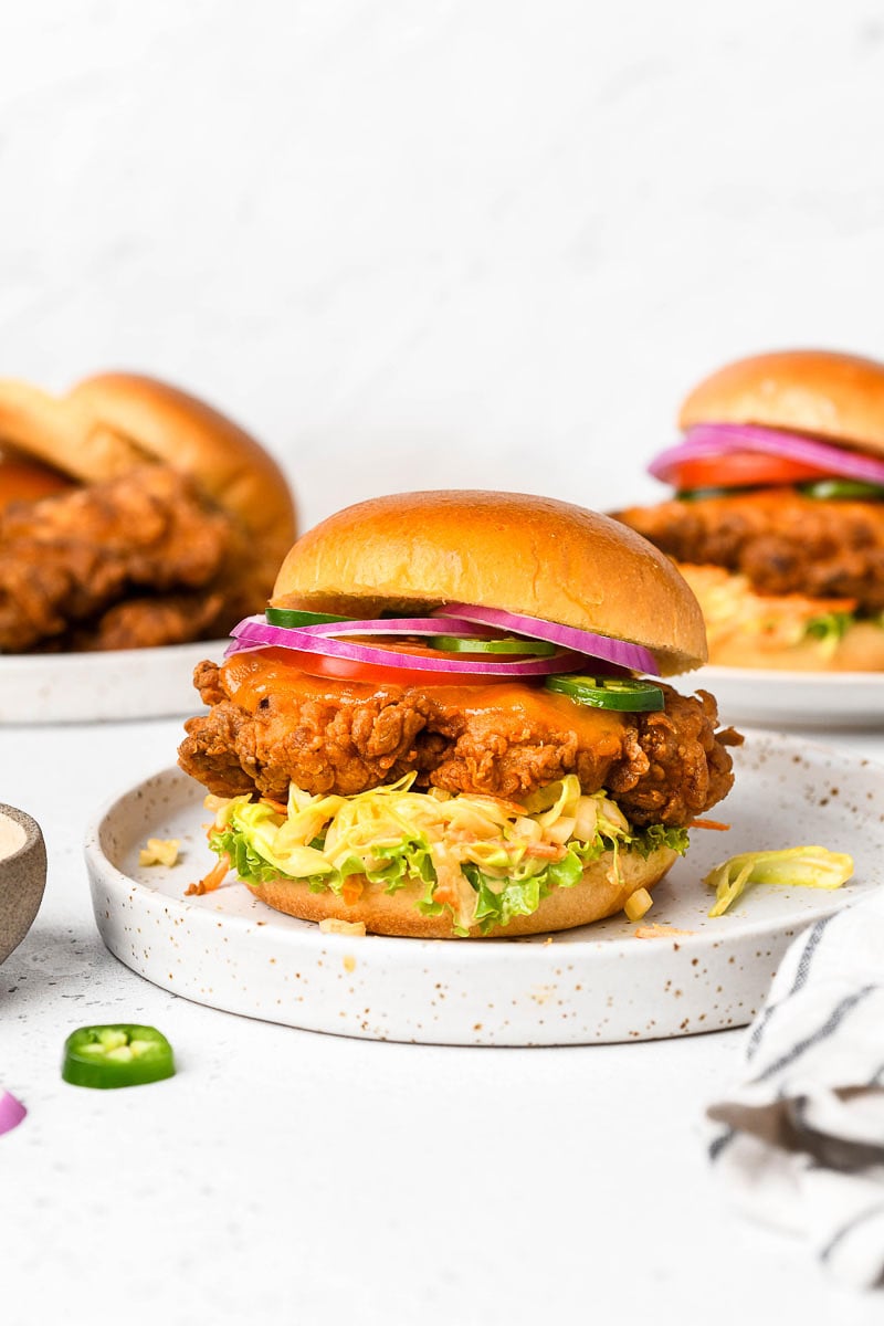 A plate with a fried chicken sandwich.