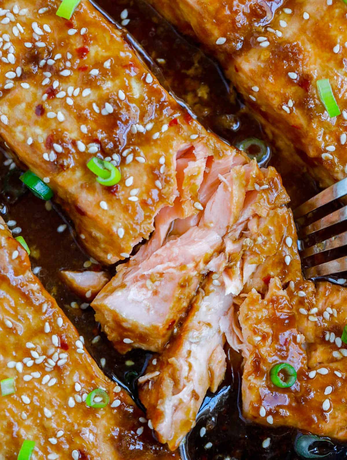 A salmon fillet flaked with a fork.