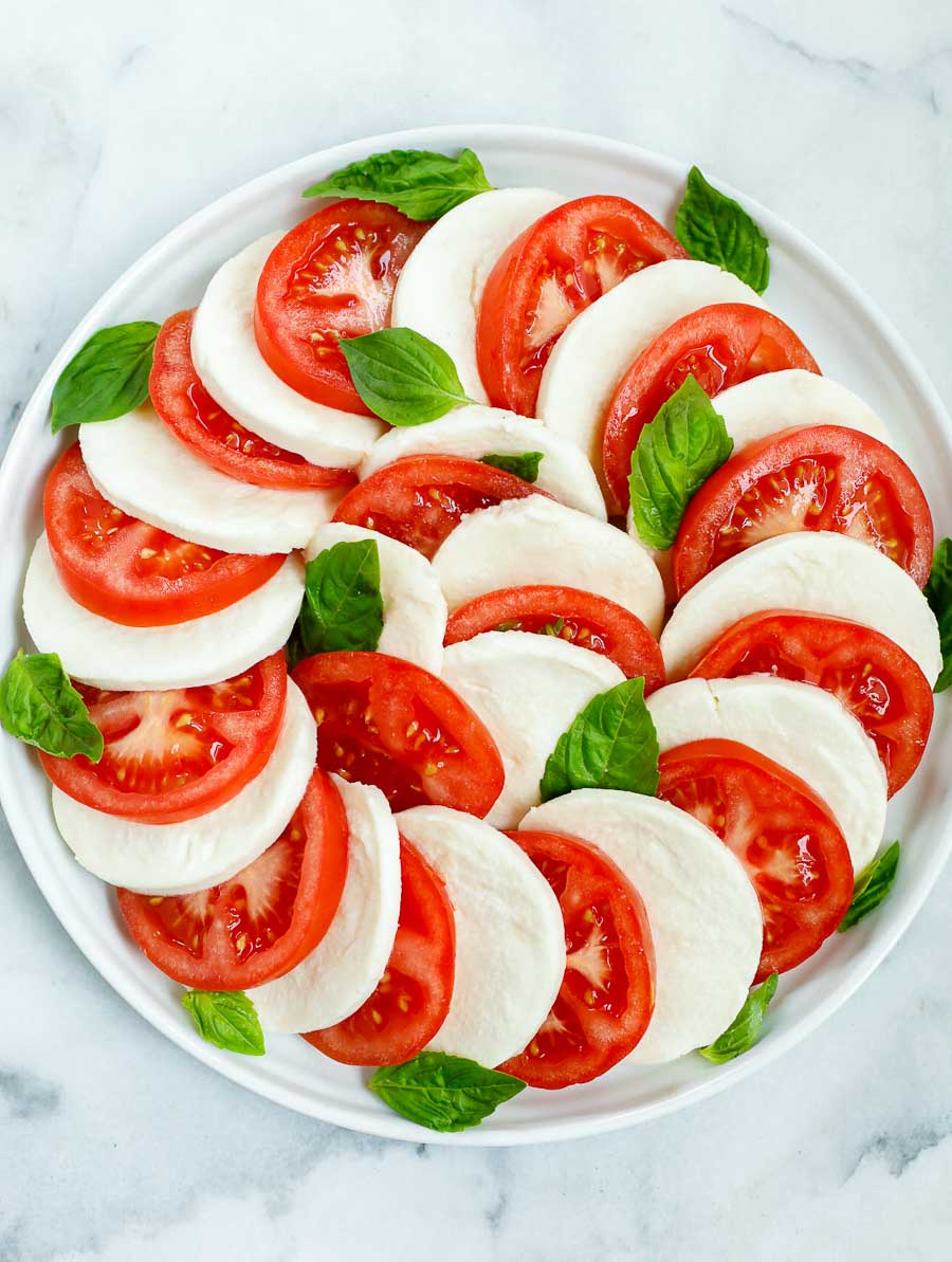 top down shot of the caprese salad after being assembled but before adding the dressing