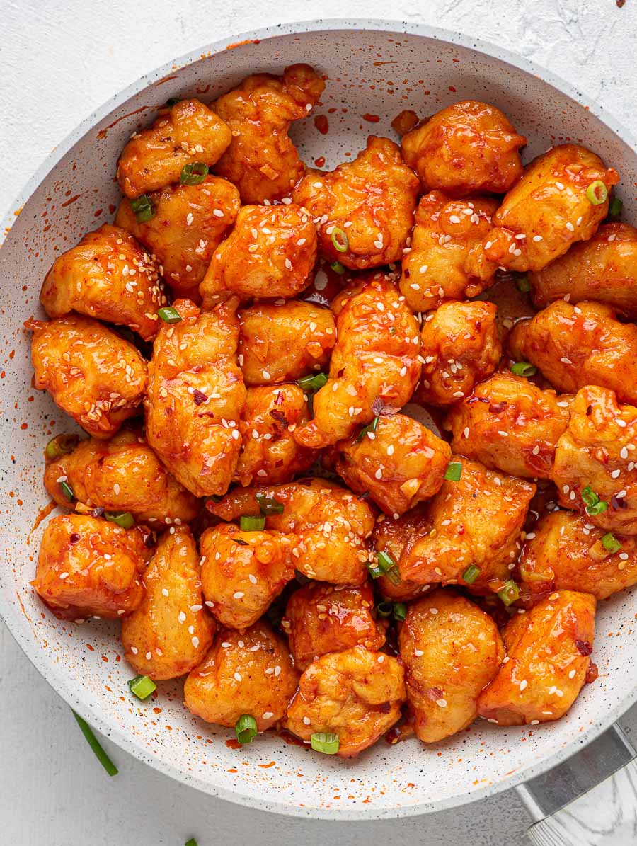 top down shot of sweet and spicy asian chicken in a skillet