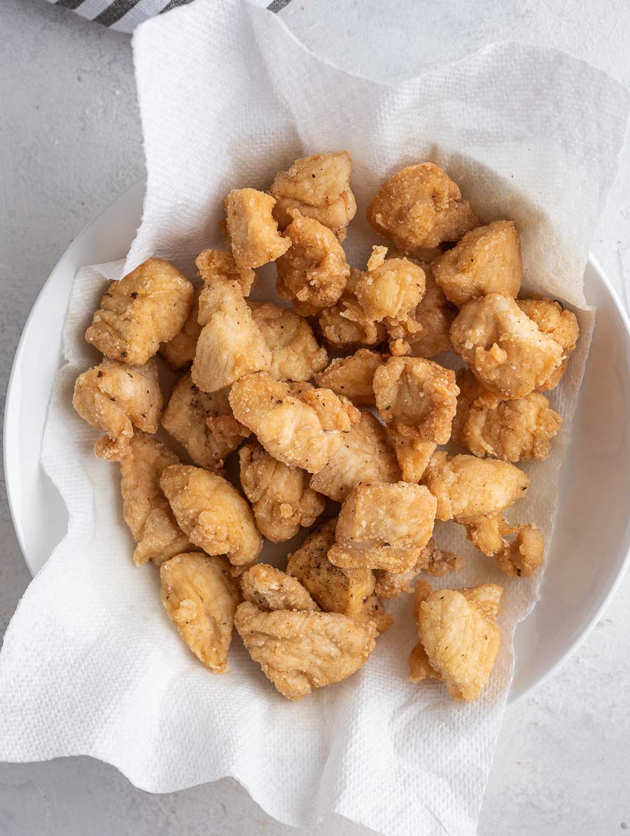 fried chicken bites in a bowl on a paper towel
