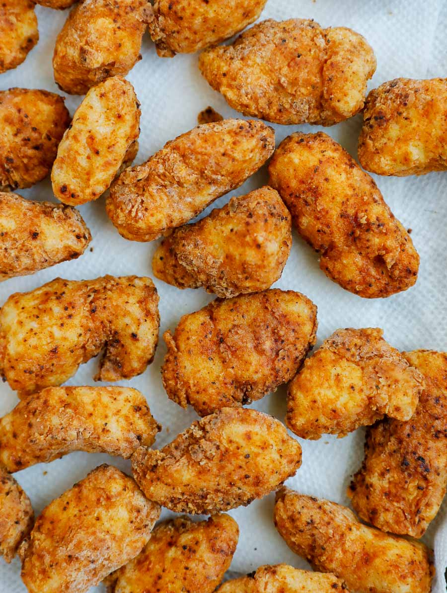chicken bites on a sheet pan lined over paper towel.