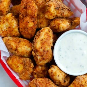 chicken bites in a red basket with a side of ranch