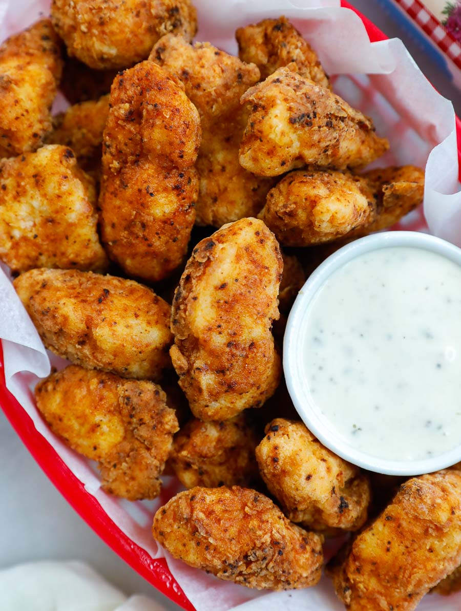 chicken bites in a red basket with a side of ranch