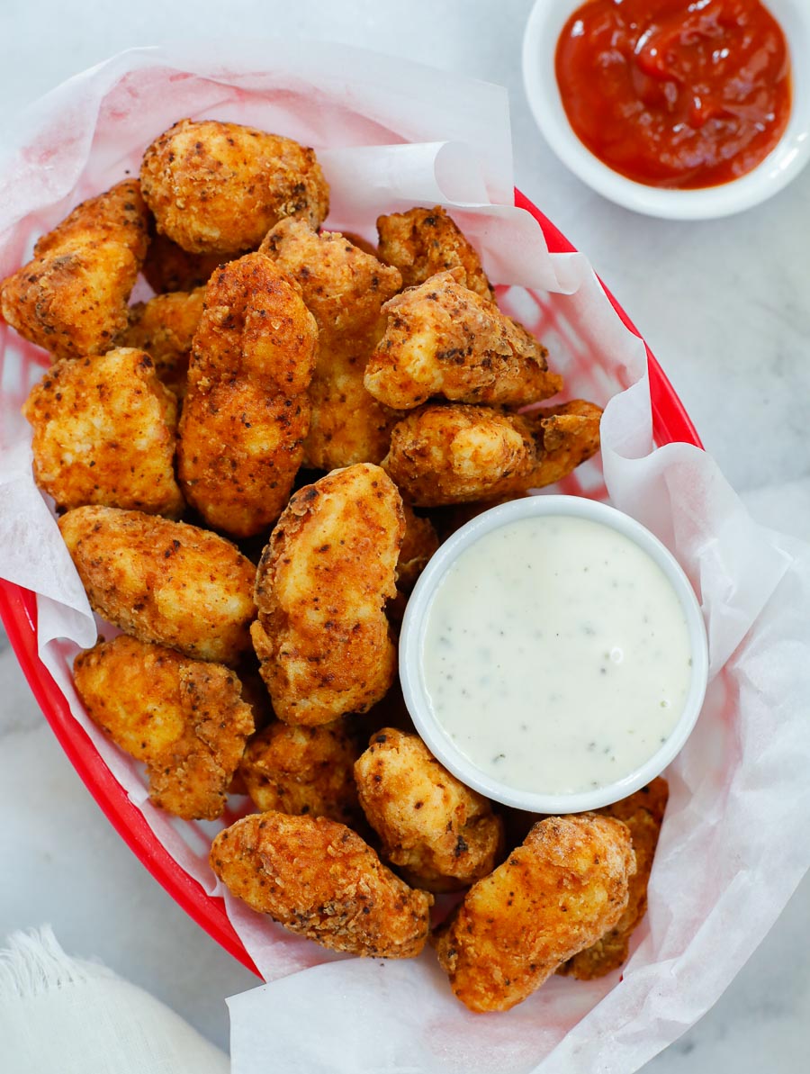 chicken bites in a red basket with a side of ranch