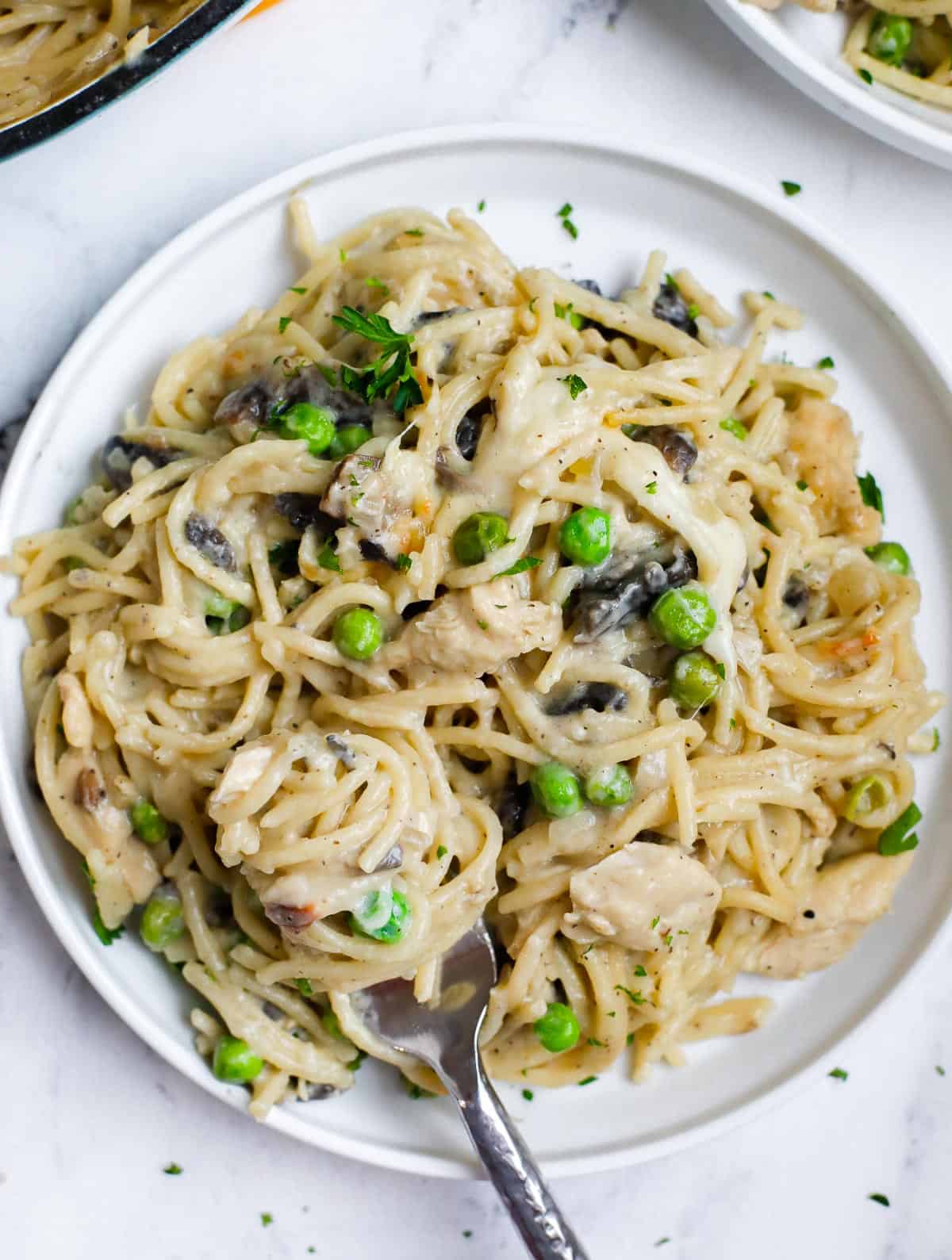 A plate of chicken tetrazzini with a fork inside.