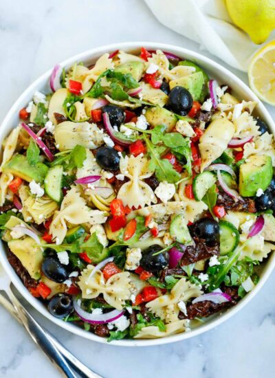 lemon herb Mediterranean salad served in a white bowl, with a side of lemon