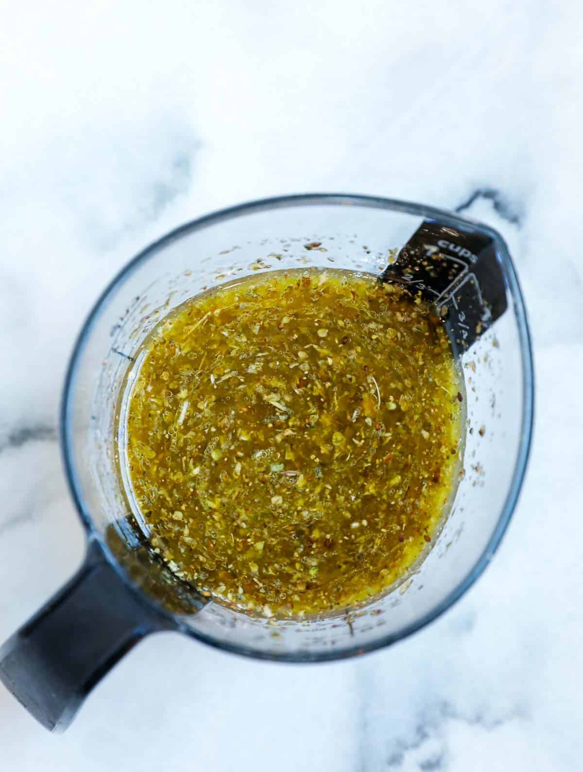 Salad dressing in a measuring cup.